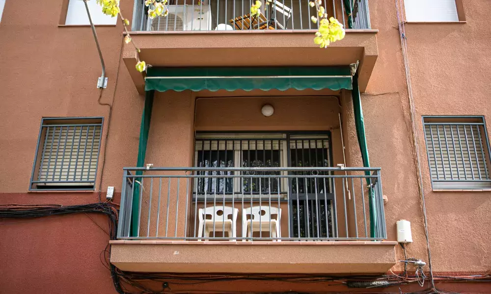 Balcony of a renovated flat with two white chais