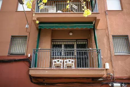 Balcony of a renovated flat with two white chais