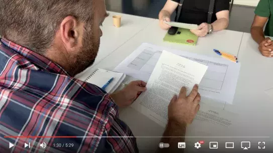 A man reading a document during one of the workshop on Rudi's governance model