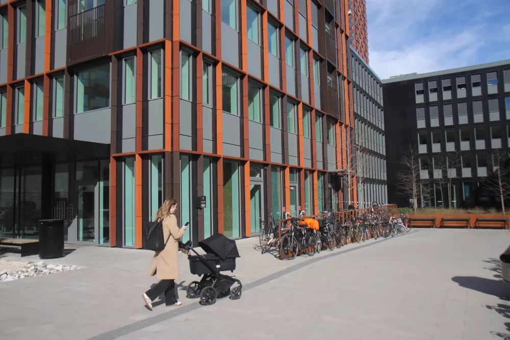 woman with pram in recently developed neighbourhood